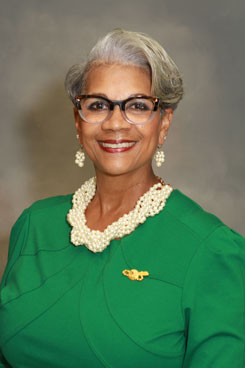 Image of President Stacy Edwards in green dress and white pearls.